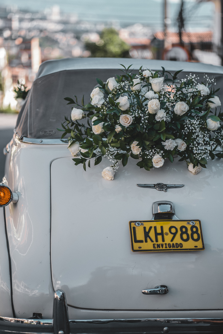 Retro car decorated with white wedding flowers